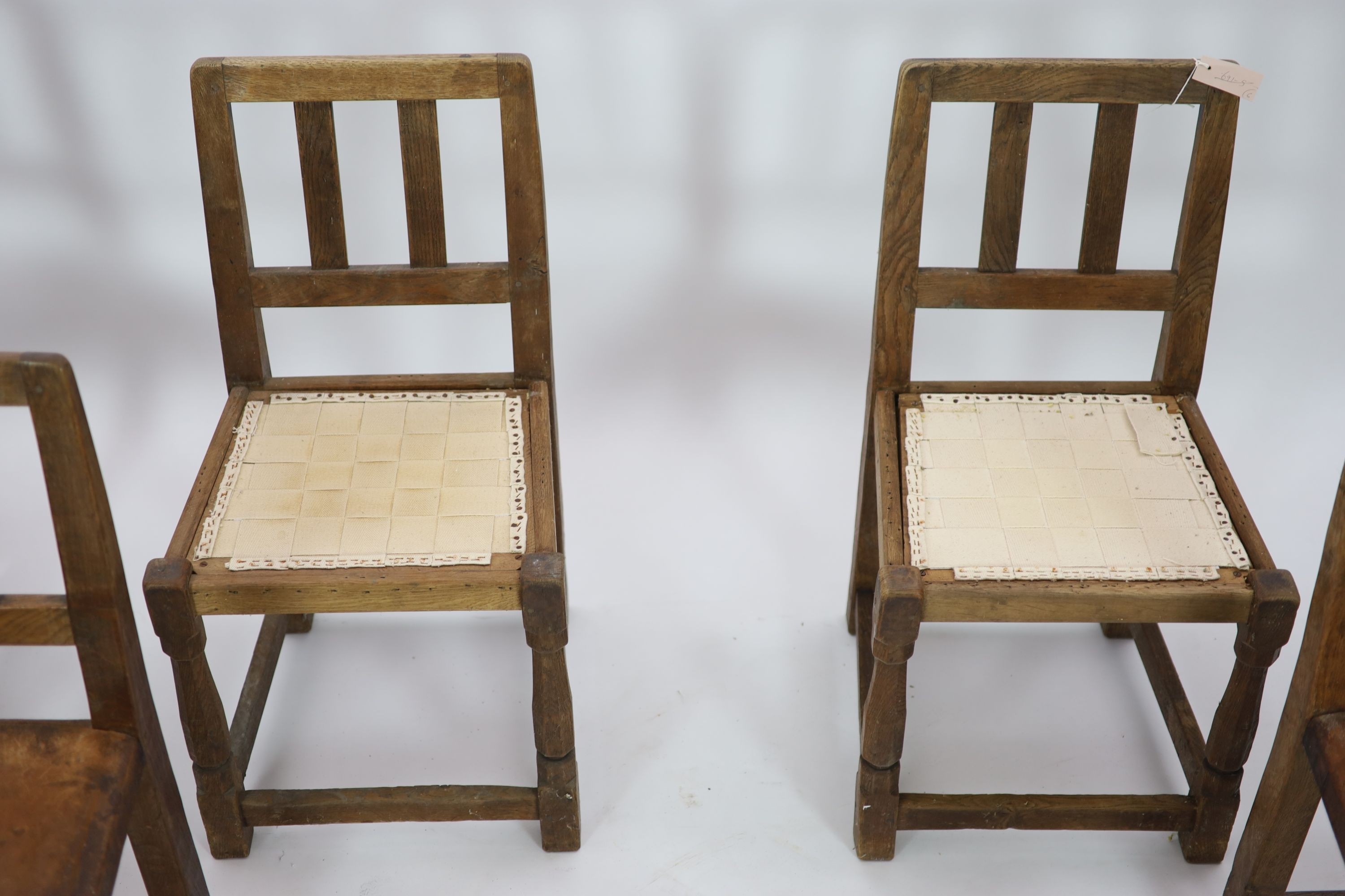 A set of six Robert Thompson 'Mouseman' oak dining chairs